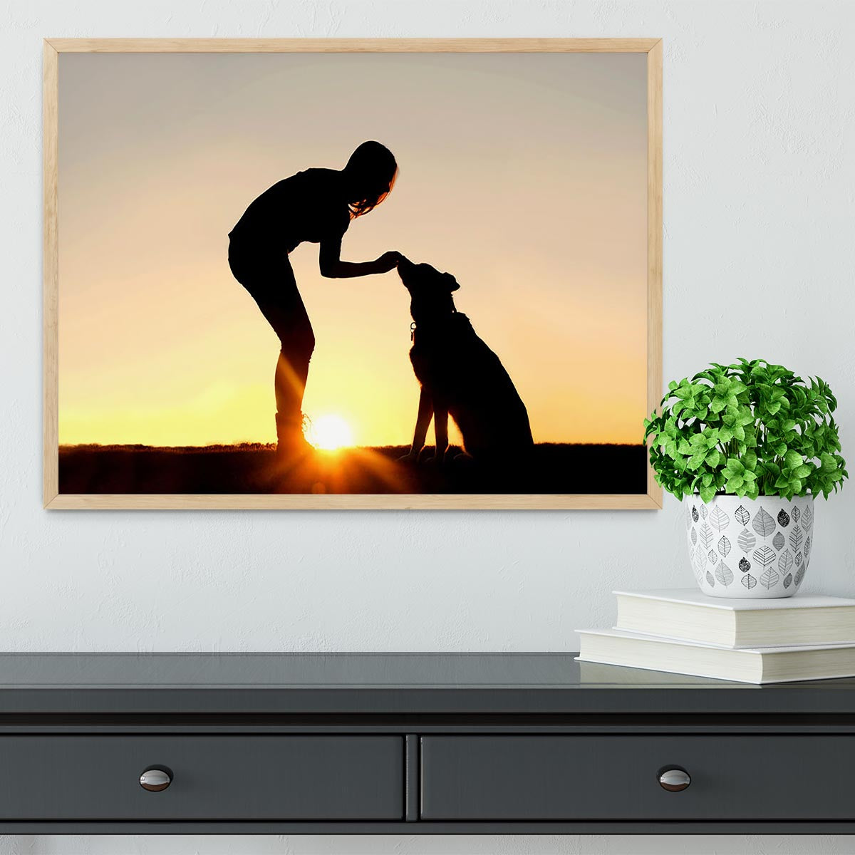 A silhouette of a girl sitting outside in the grass with her pet German Shepherd Mix Dog feeding him treats during training in front of a sunsetting sky. Framed Print - Canvas Art Rocks - 4