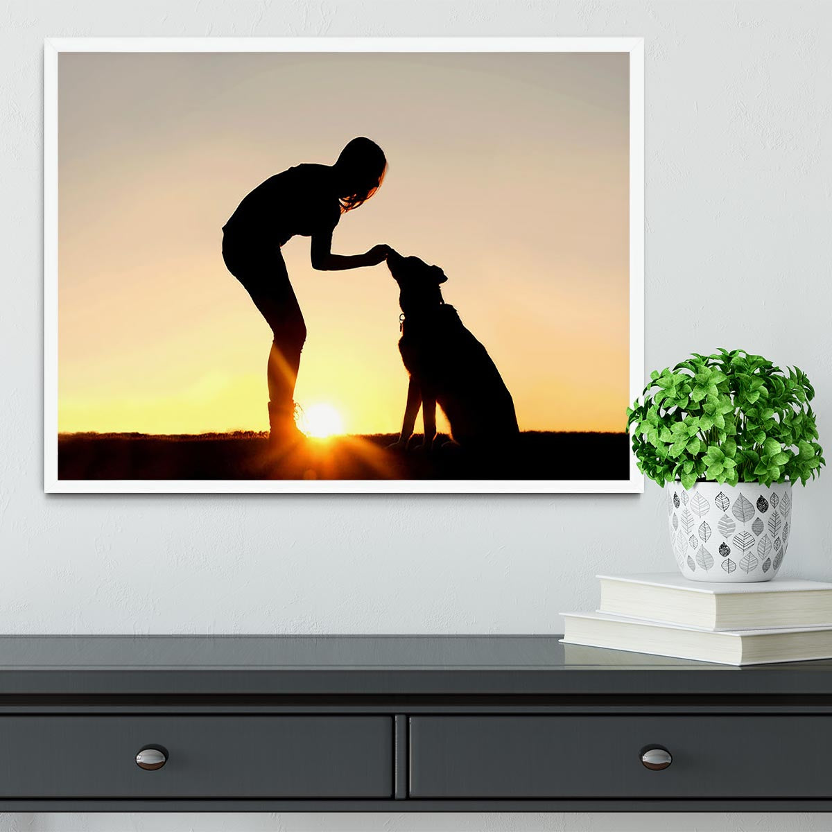 A silhouette of a girl sitting outside in the grass with her pet German Shepherd Mix Dog feeding him treats during training in front of a sunsetting sky. Framed Print - Canvas Art Rocks -6
