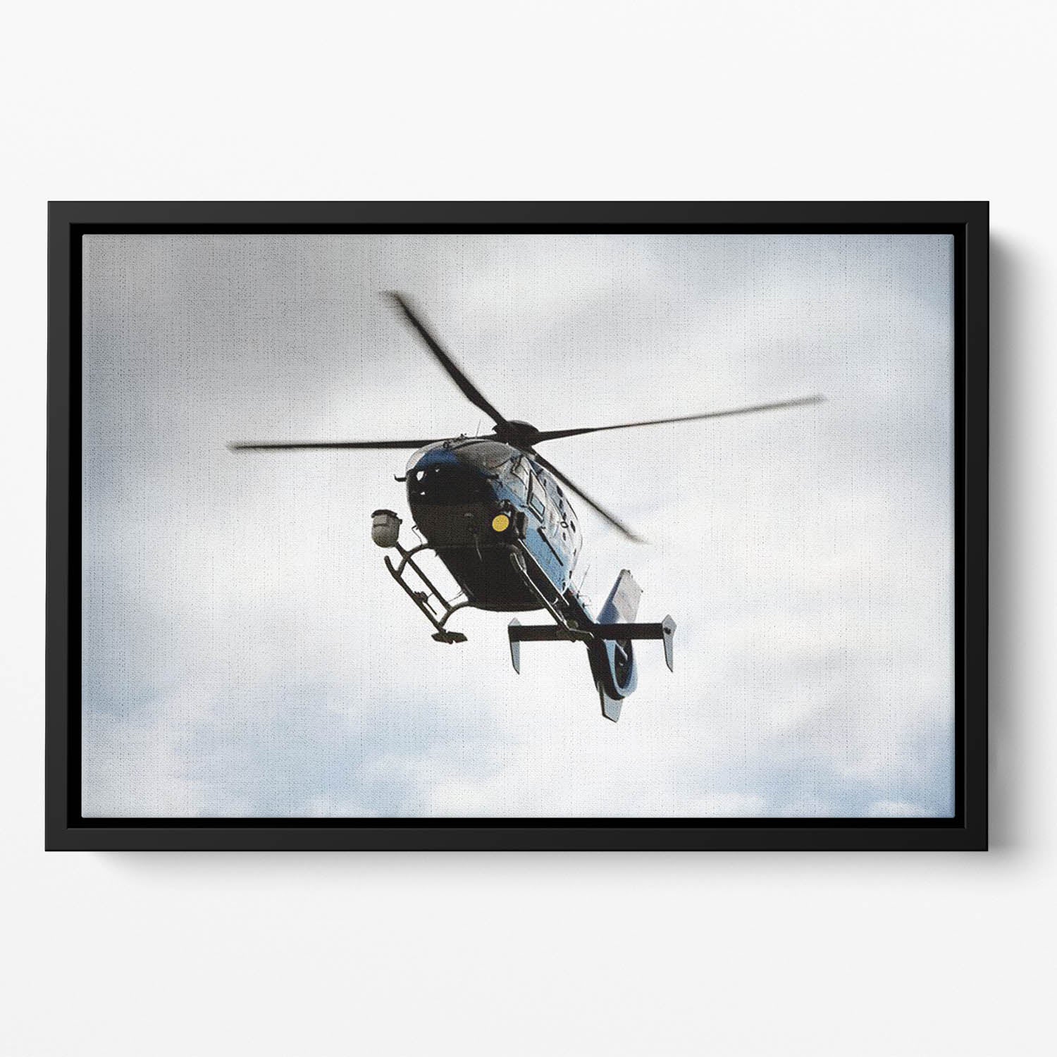 Blue and silver police helicopter flying above Floating Framed Canvas