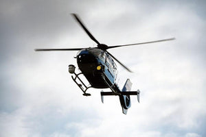 Blue and silver police helicopter flying above Wall Mural Wallpaper - Canvas Art Rocks - 1