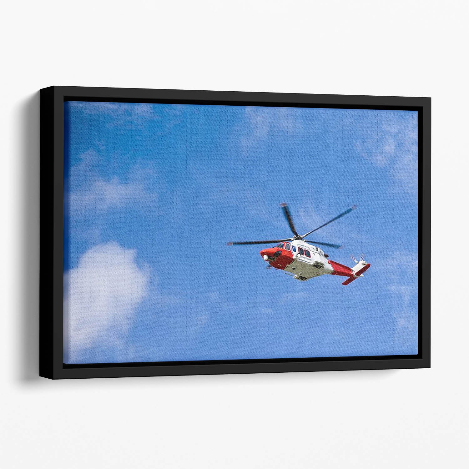 Coastguard helicopter in the blue sky Floating Framed Canvas