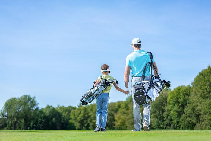 Father and son on golf course Wall Mural Wallpaper