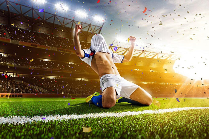 Soccer player in action on night stadium Wall Mural Wallpaper