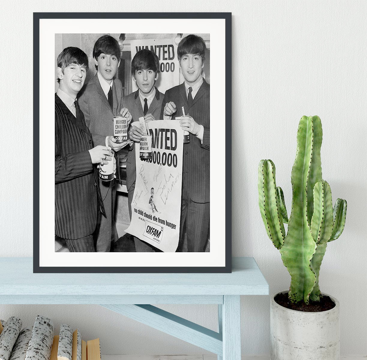 The Beatles with an Oxfam poster Framed Print - Canvas Art Rocks - 1